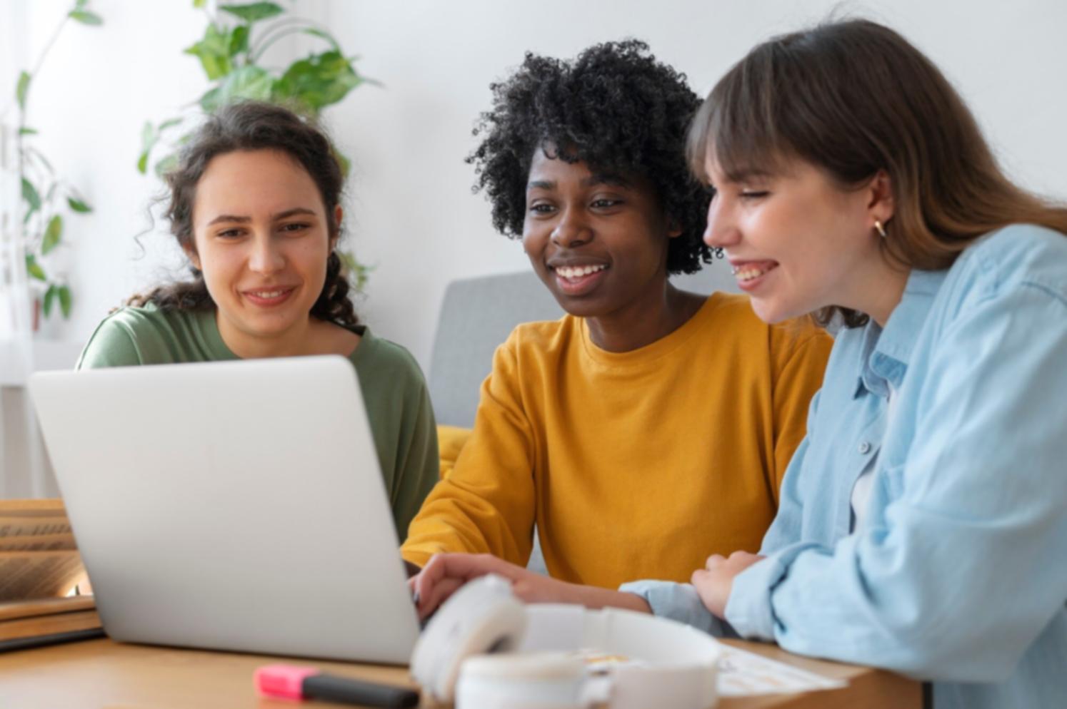 Professional reviewing financial documents with laptop showing remote learning platform